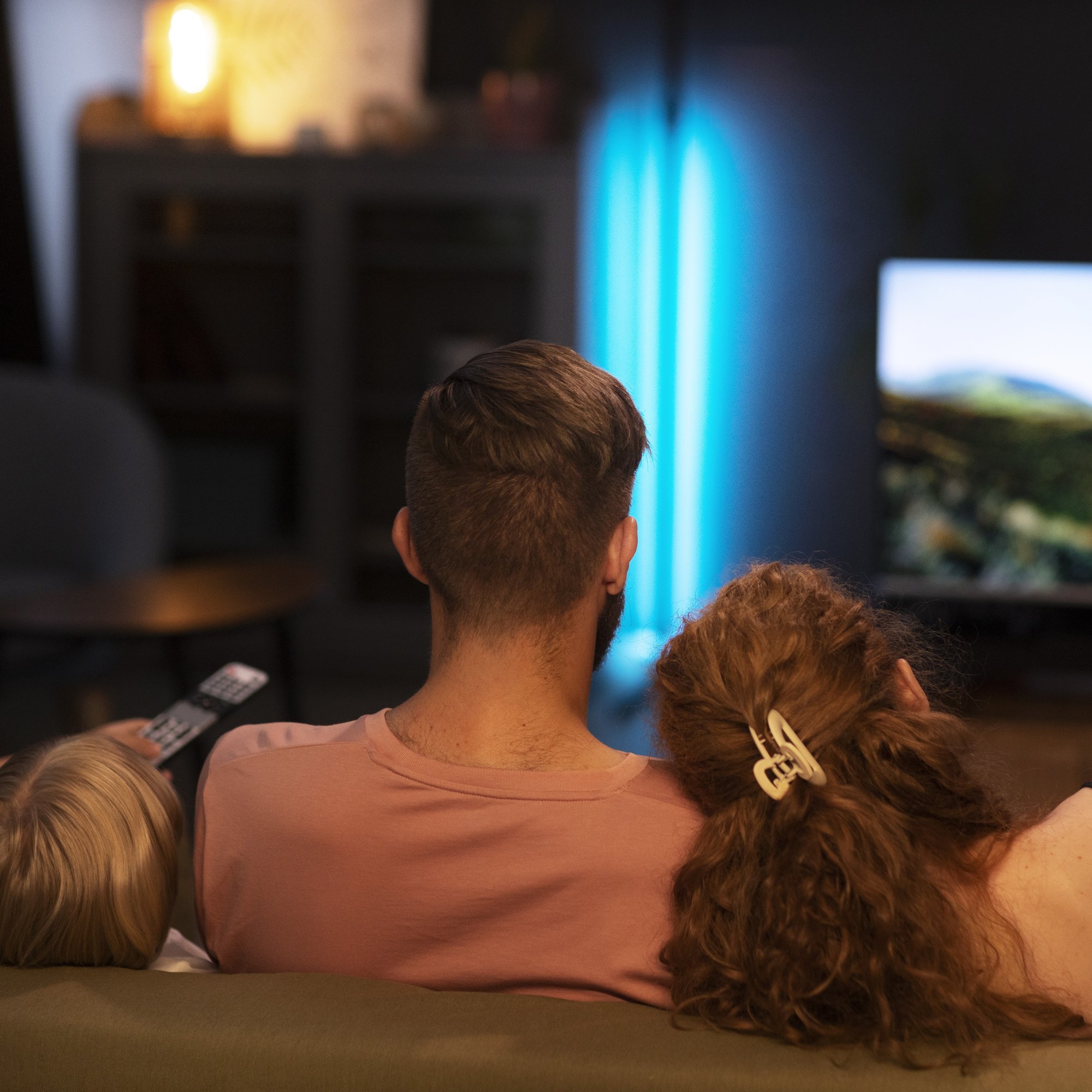 back-view-family-watching-tv