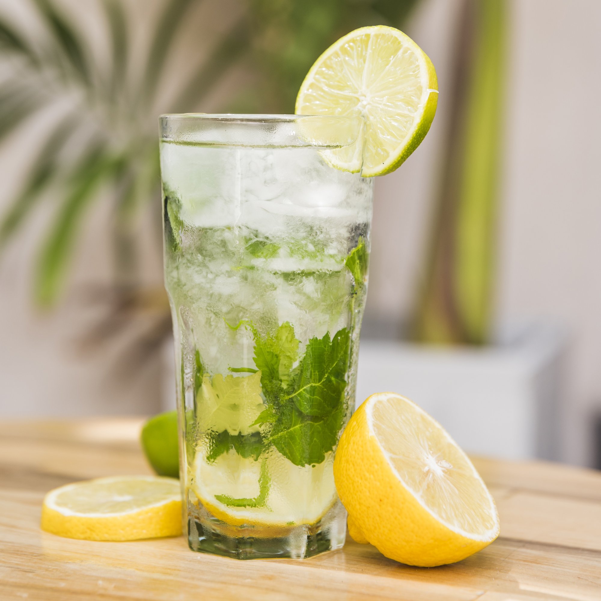 slices-fruits-near-glass-drink-with-ice-herbs-table slices-fruits-near-glass-drink-with-ice-herbs-table