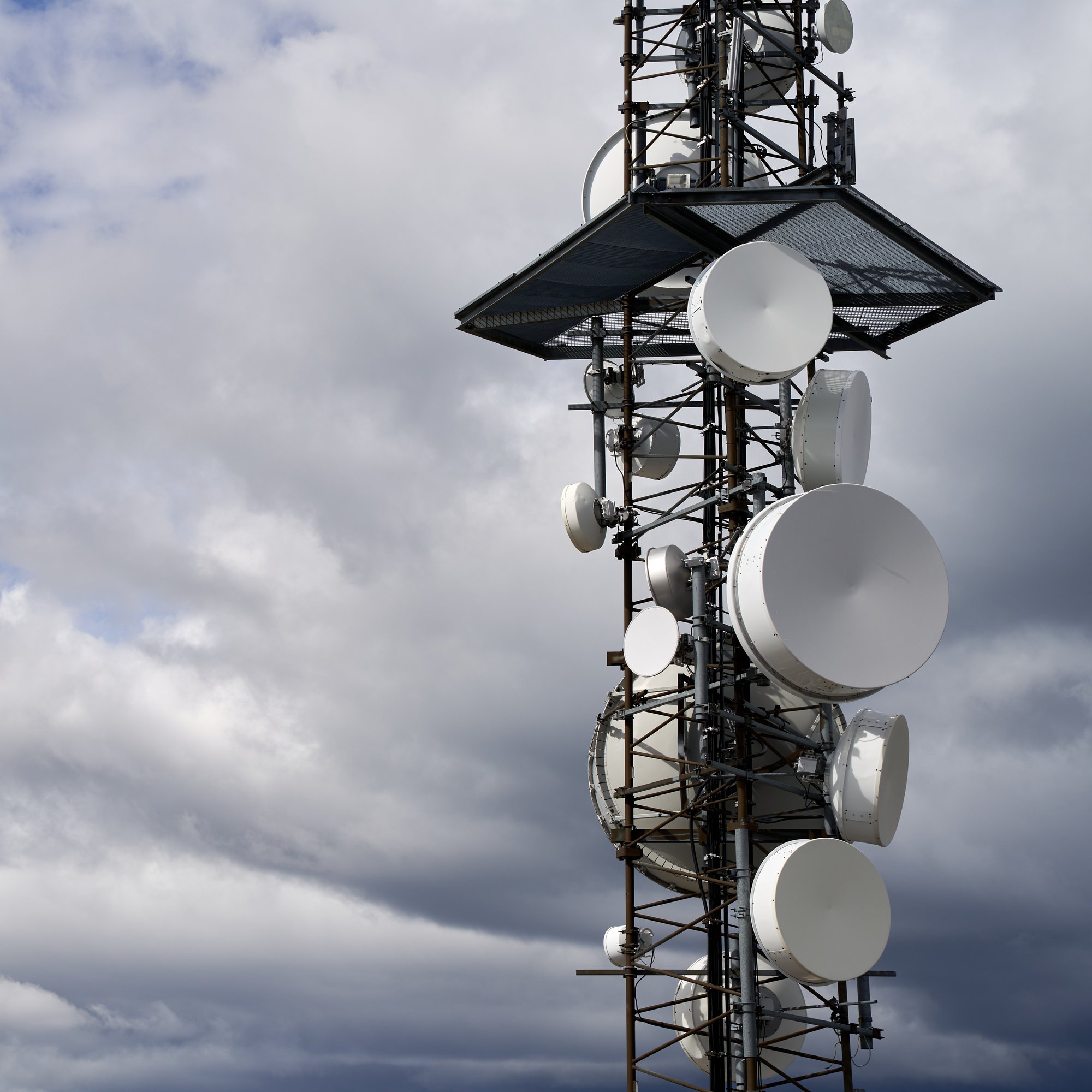 telecommunications-towers-against-cloudy-sky telecommunications-towers-against-cloudy-sky